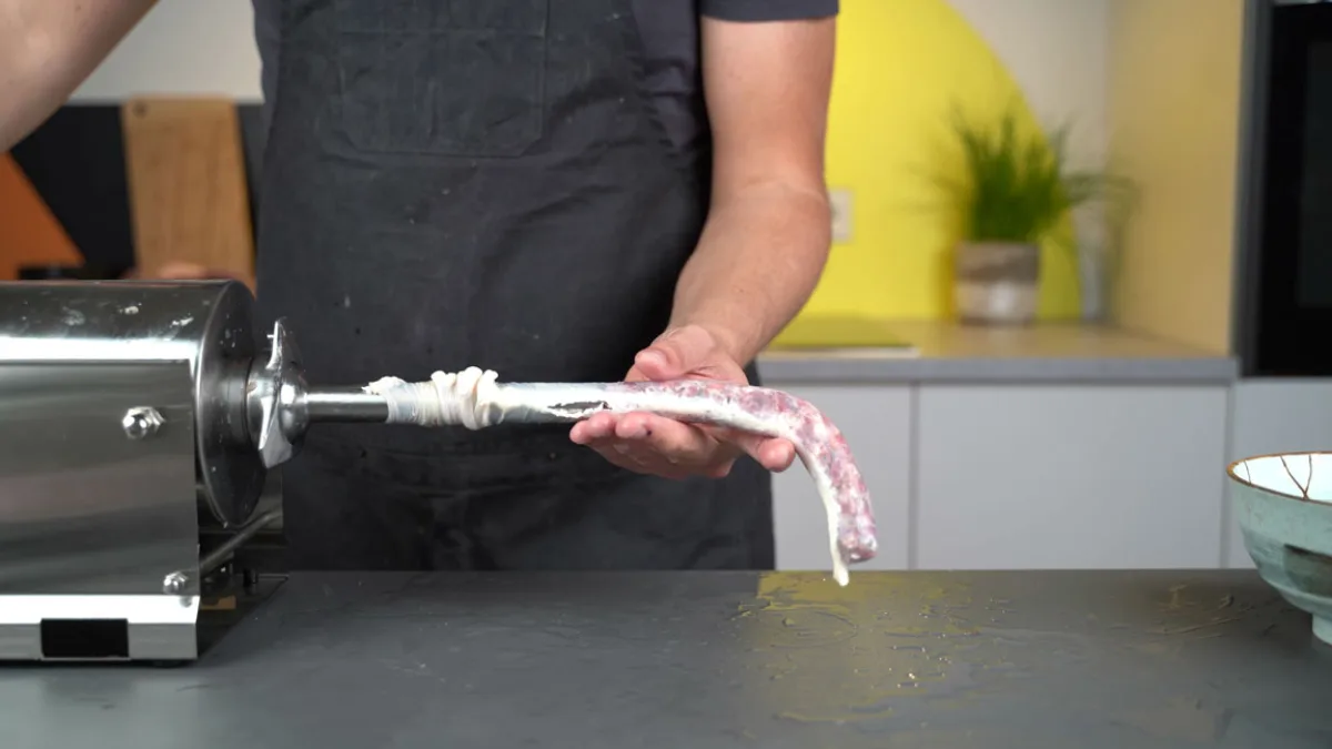 Daniel filling Franconian Bratwurst into casings with a sausage stuffer