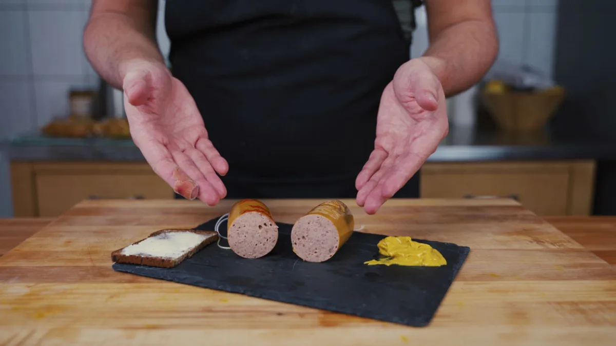 Homemade Lyoner sliced open on a serving board
