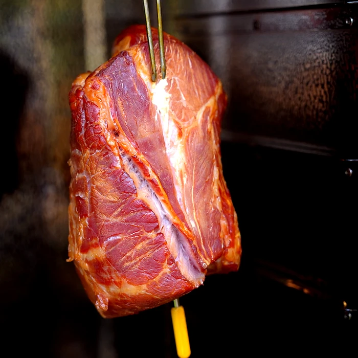 Cooked ham in hot smoke