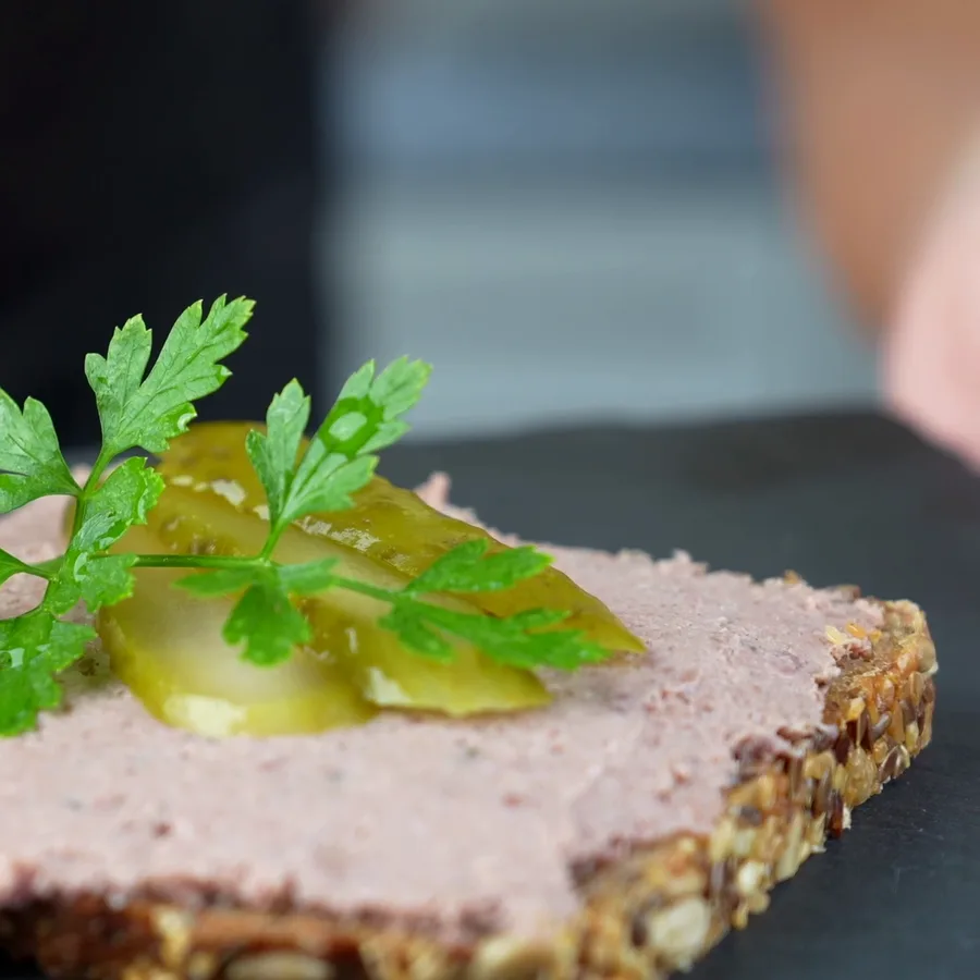Homemade country liver sausage in a jar and on bread