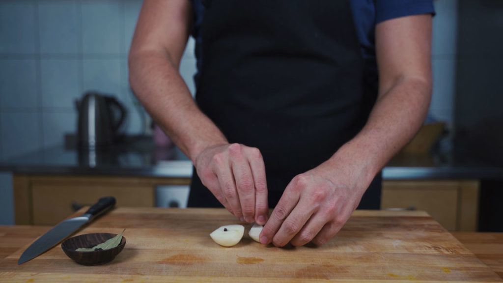 Studding an onion with cloves