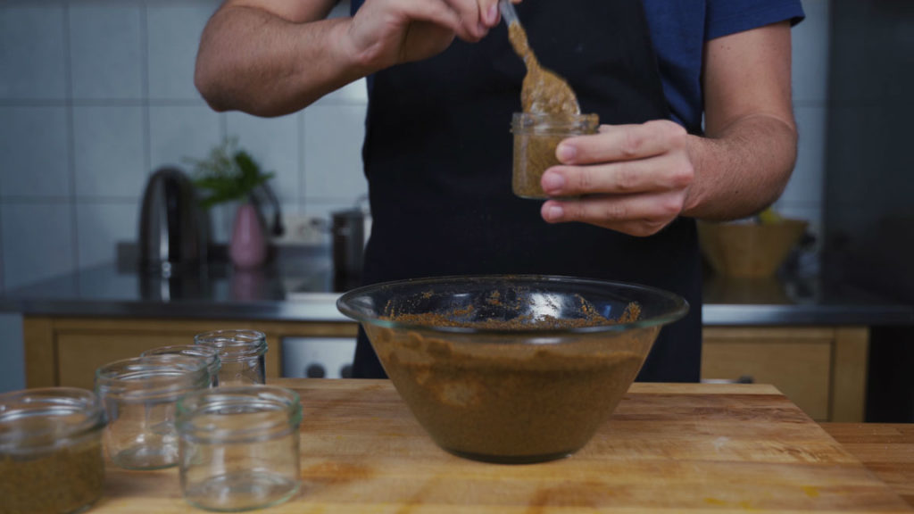 Filling jars with sweet mustard