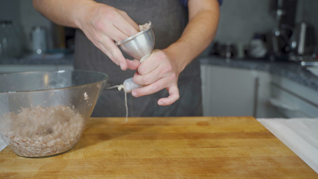 Filling natural casings with Bregenwurst mixture