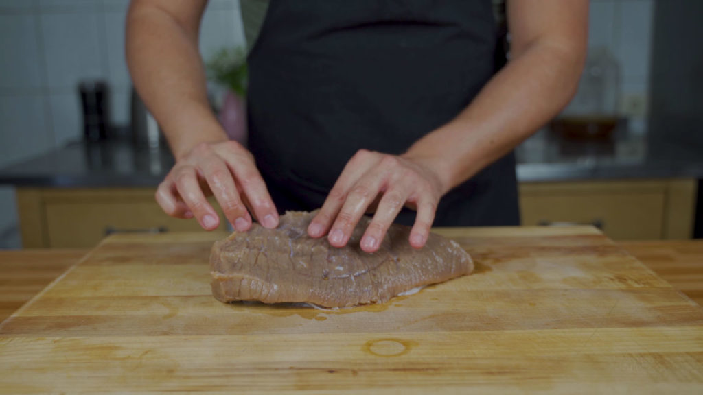 Rinsing cured corned beef under cold water