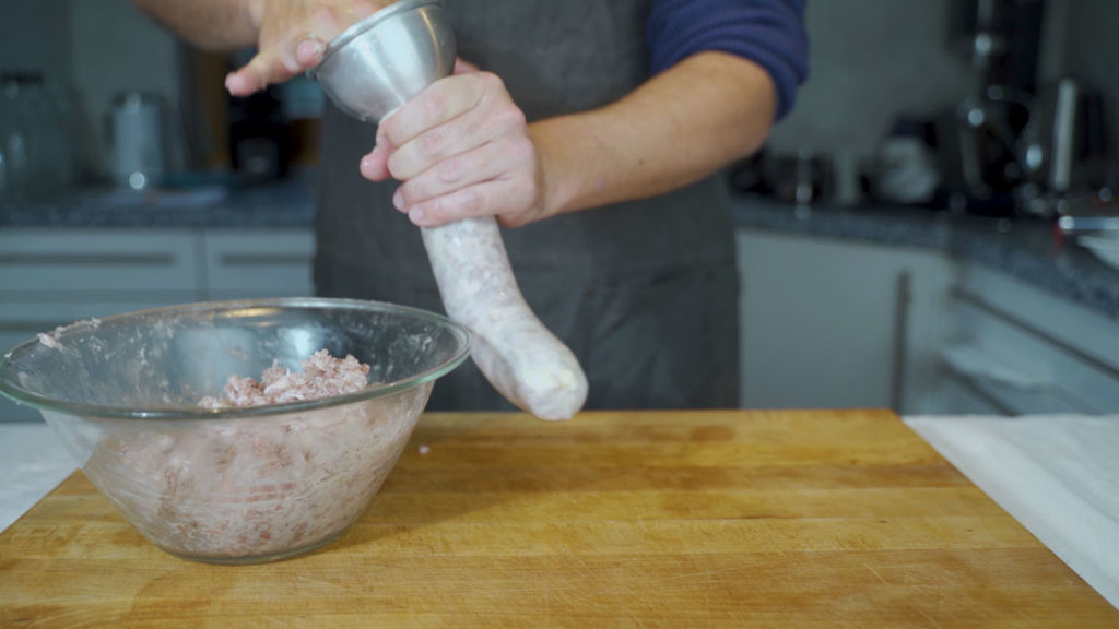 Filling a fibrous casing with cotechino mixture