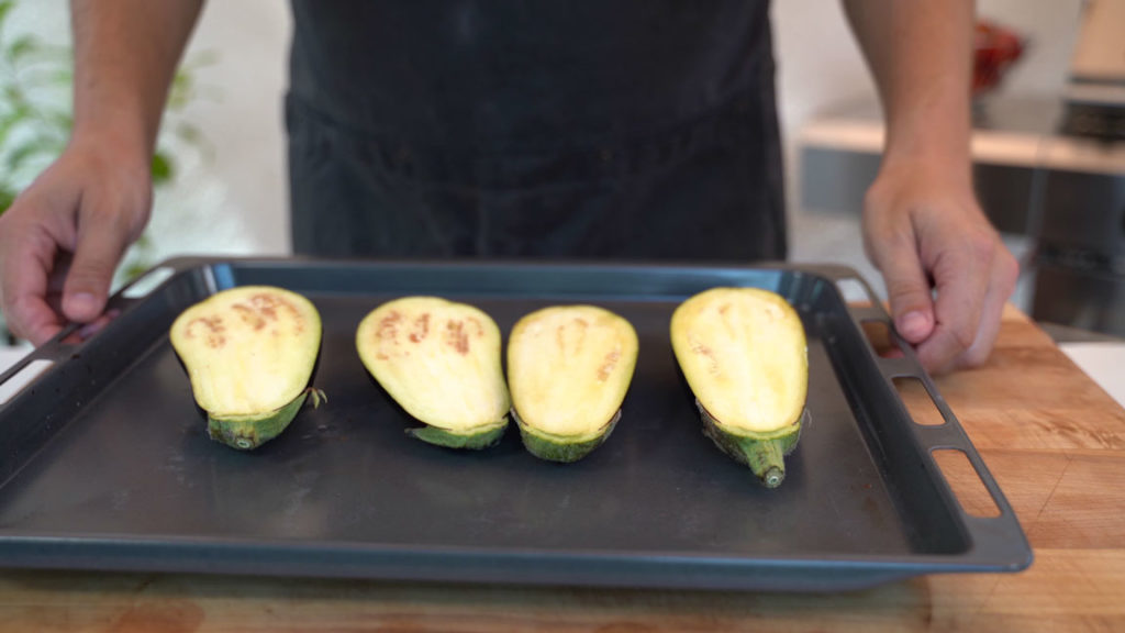 Oiled eggplants on a baking sheet