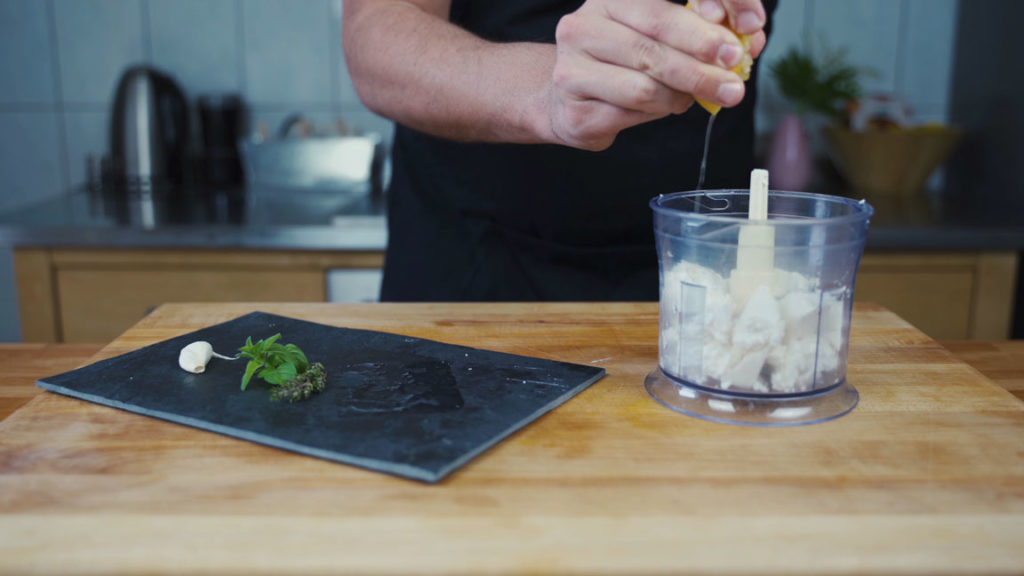 Adding lemon juice to the feta