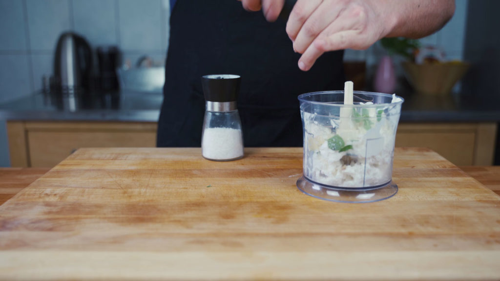Seasoning feta spread with salt and pepper