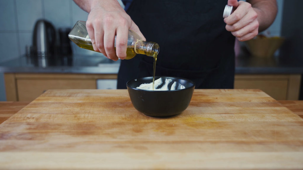 Stirring olive oil into feta spread