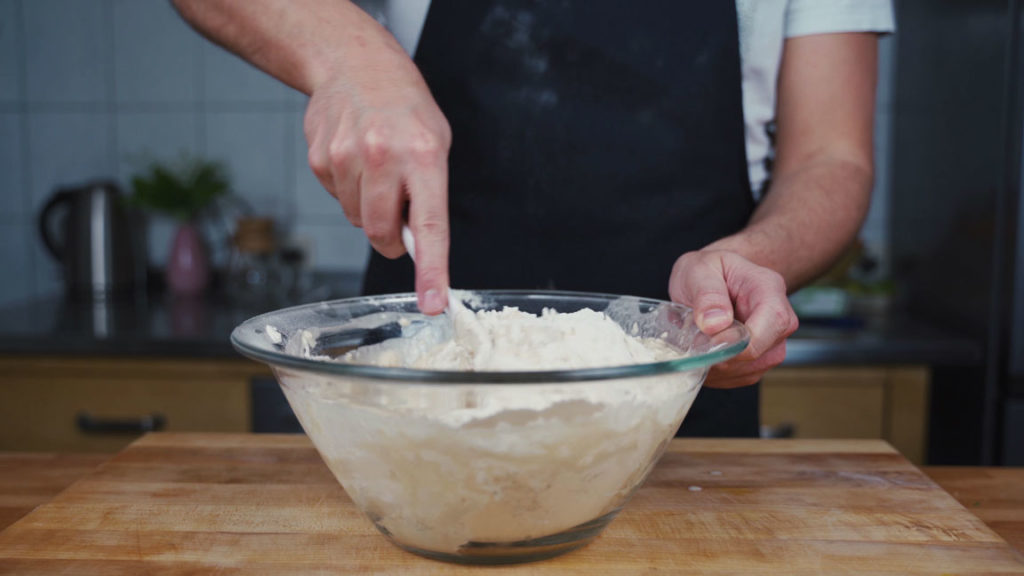 Working butter into the pretzel dough