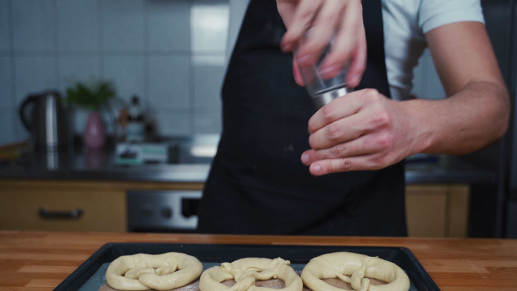 Sprinkling the pretzels with salt