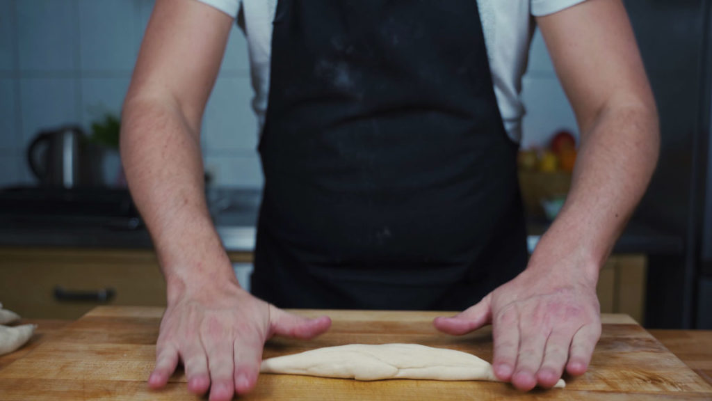 Rolling a piece of dough into a long rope