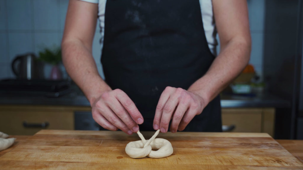 Pressing the pretzel ends into place