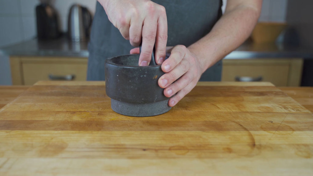 Salt, sugar and spices in a mortar for gravlax