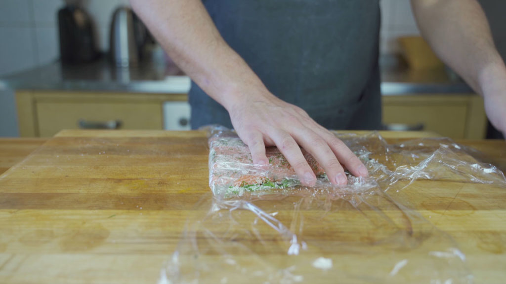 Salmon wrapped in plastic wrap for gravlax