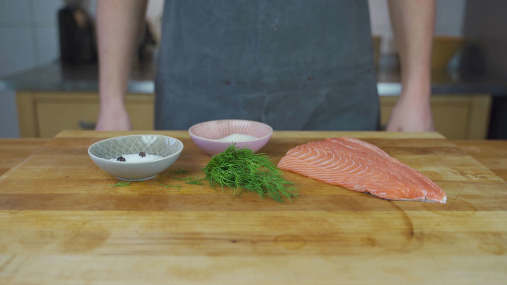 All the gravlax ingredients: salmon fillet, salt, sugar, dill, juniper and allspice