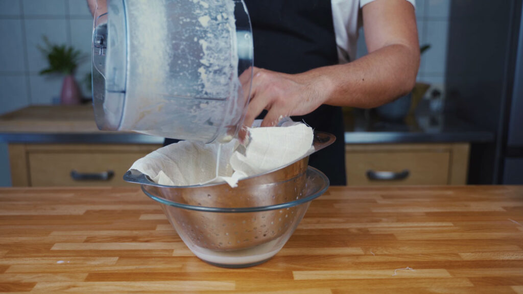 Pouring butter through a sieve
