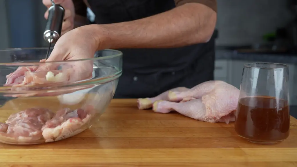 Injecting the chicken legs with brine