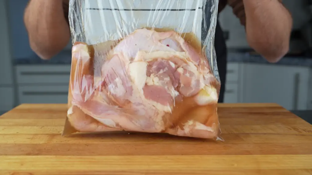 Sealed bag with chicken legs curing in the brine