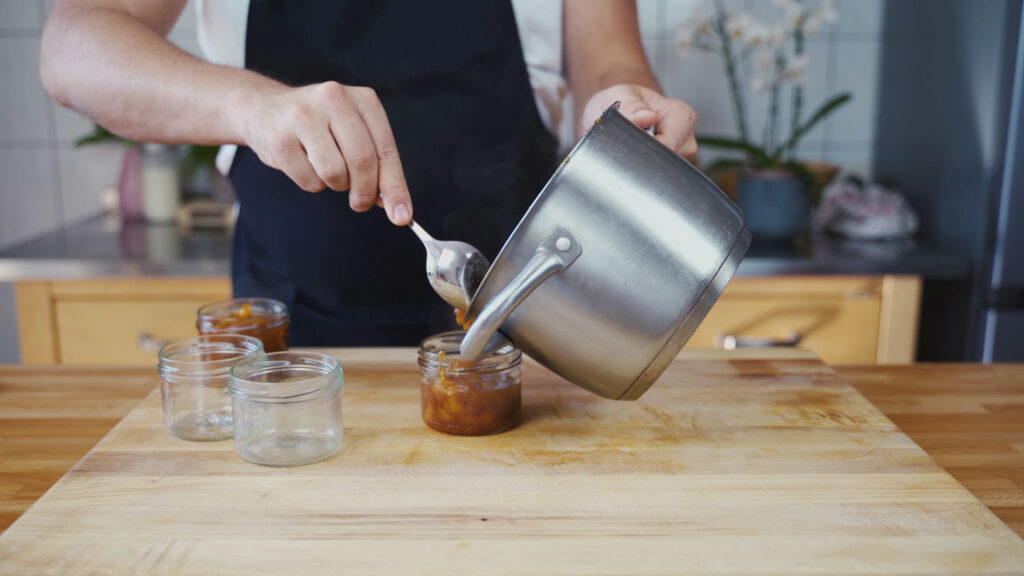 Filling the jars with mango chutney