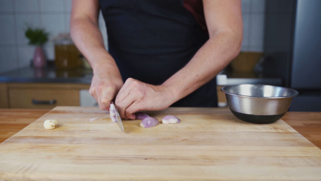 Chopping shallots, garlic and rosemary for mushroom spread