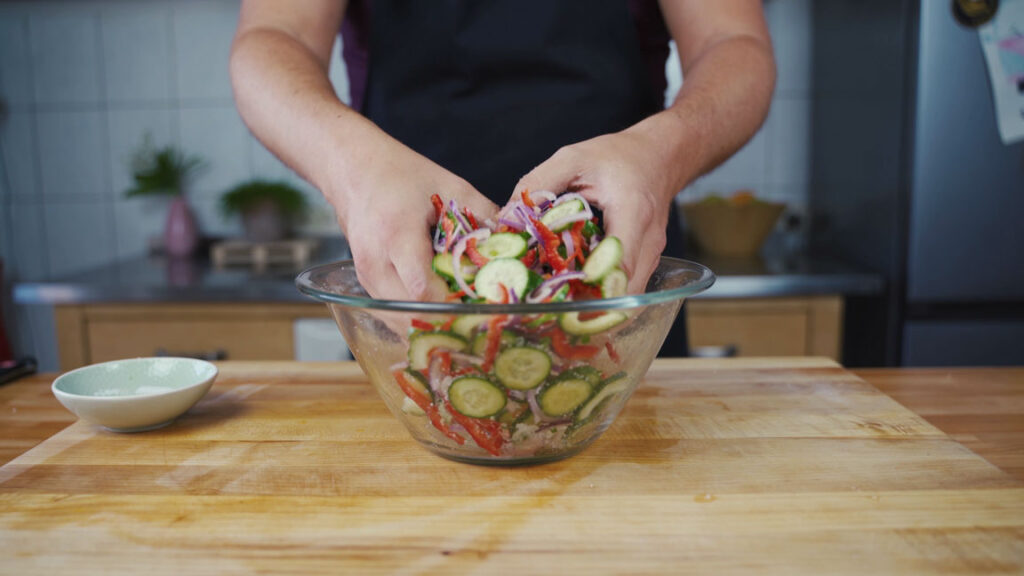 Mixing the salt into the cucumbers