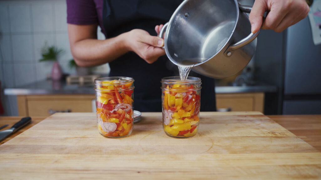 Pouring the pickling liquid into the jars