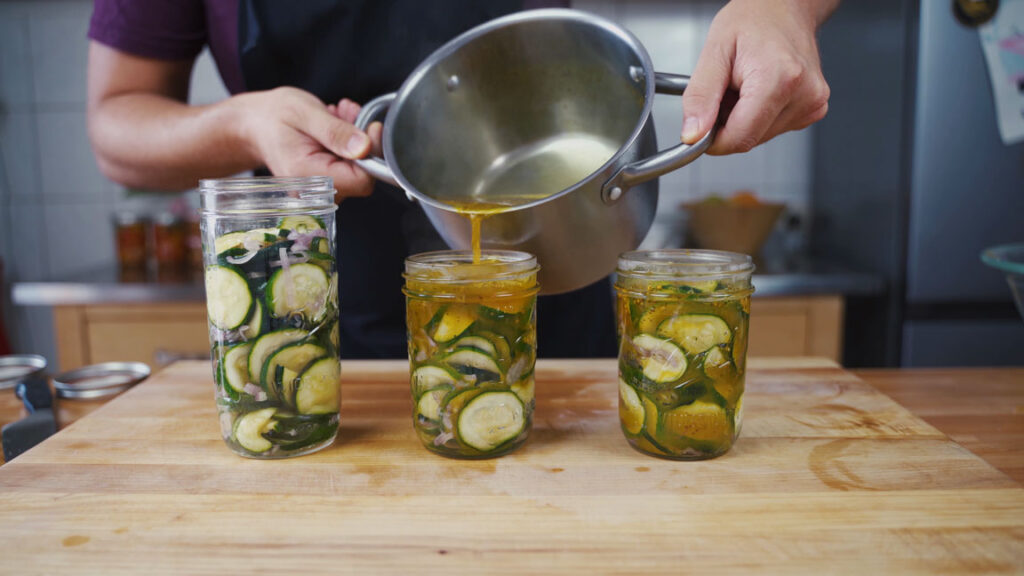 Pouring hot pickling liquid into the jars