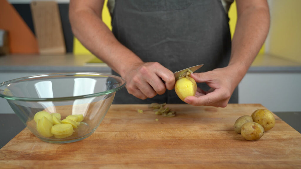 Peeling and cutting potatoes into strips