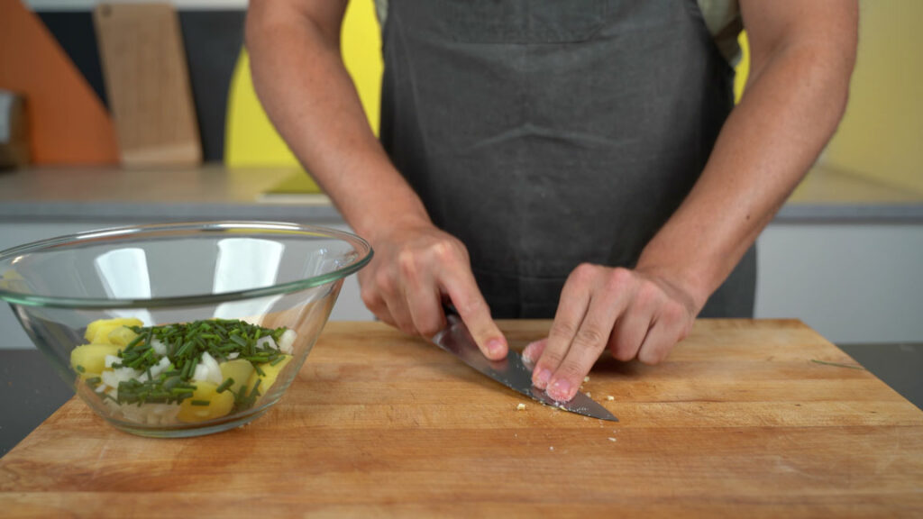Crushing garlic with salt into a paste