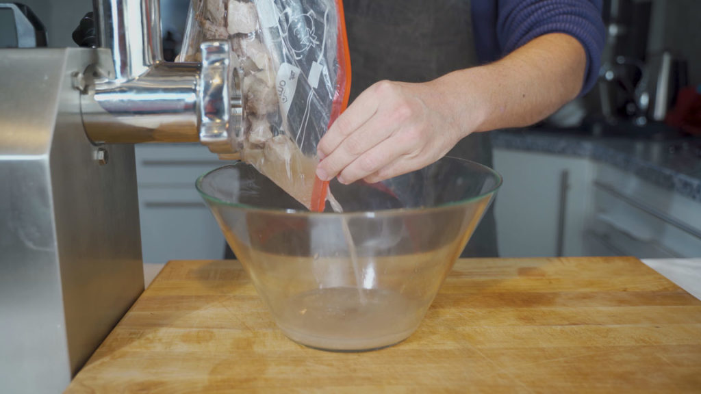 Separating the juices from the cooked pork belly