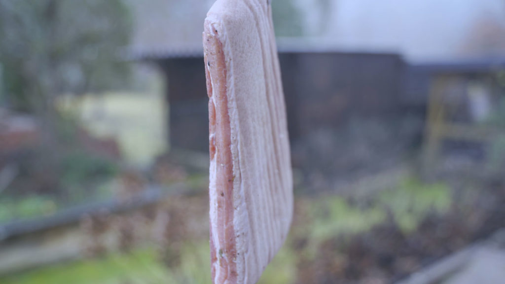 Hanging pork belly to dry before smoking