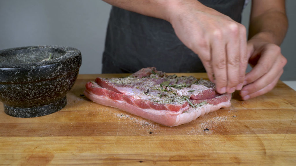 Rubbing the pork belly with the cure mixture