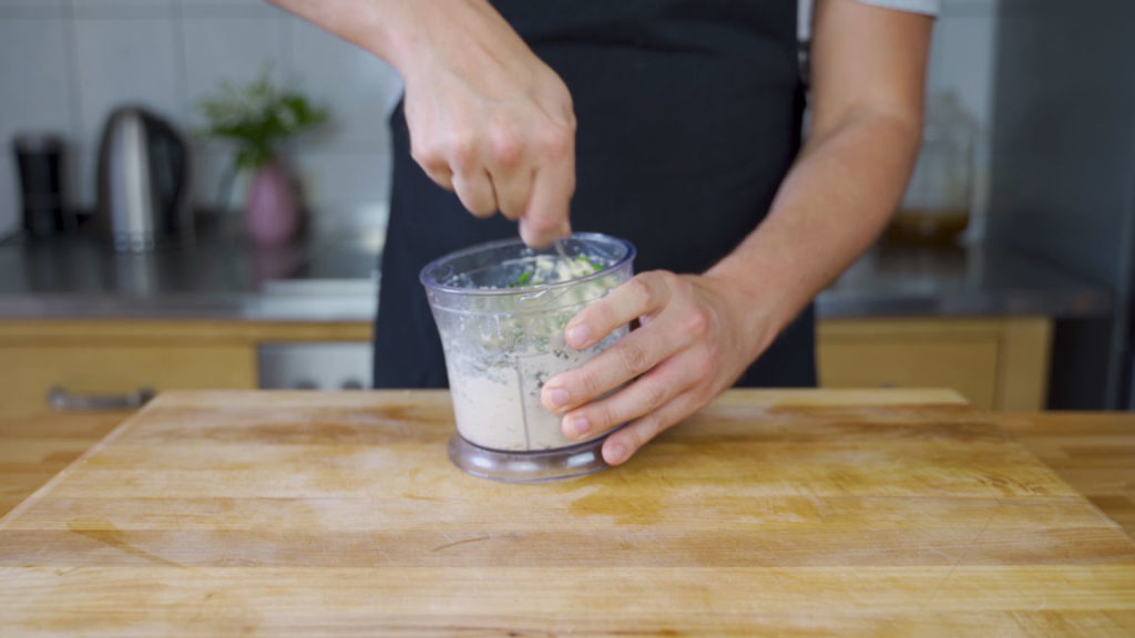 Stirring fresh herbs into tofu spread