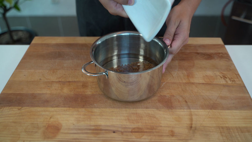 Small brown lentils (Berglinsen) cooking in a pot for vegan liverwurst
