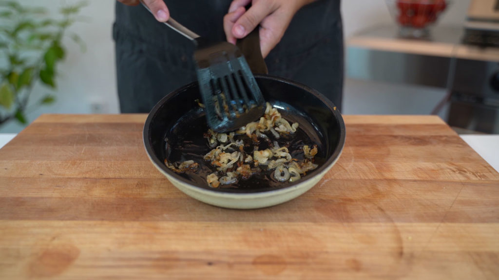 Frying onions in a pan until translucent