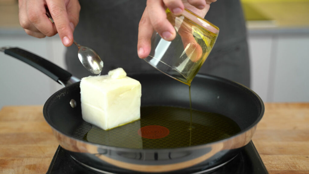 Melting refined coconut oil and canola oil in the pan
