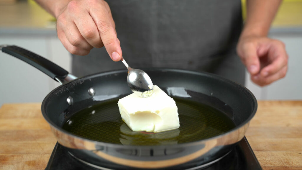 Melted refined coconut oil in the pan at 100 °C (212 °F)