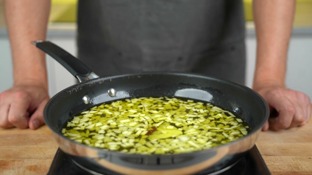 Onions and apples cooking in fat at 100 °C (212 °F)
