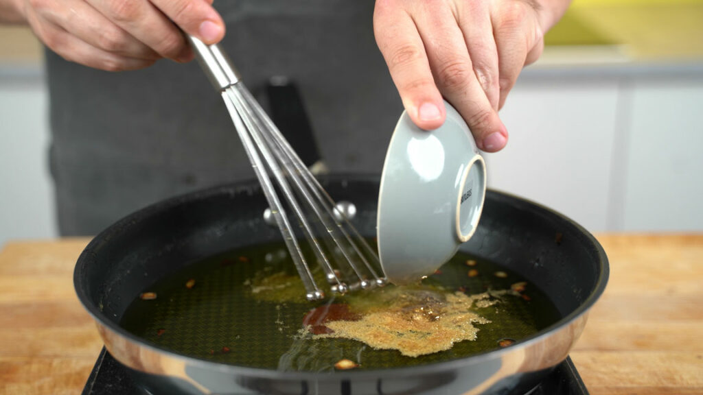 Adding seasonings to the warm fat