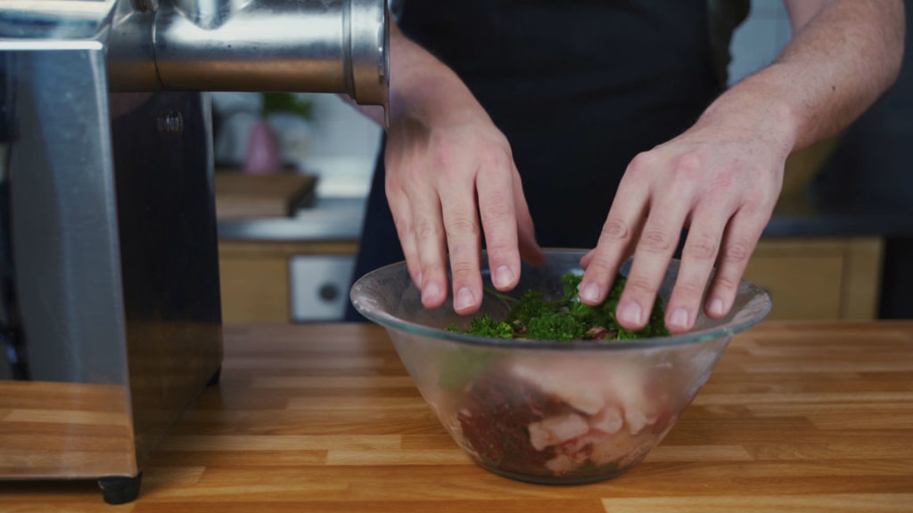 Adding parsley to the meat