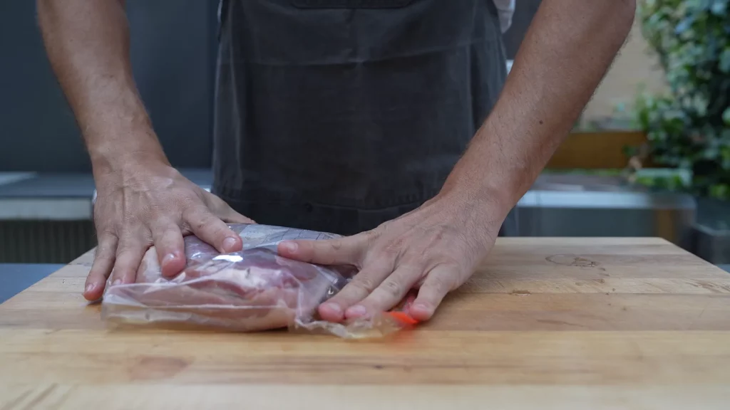 Closing the bag around the pork belly