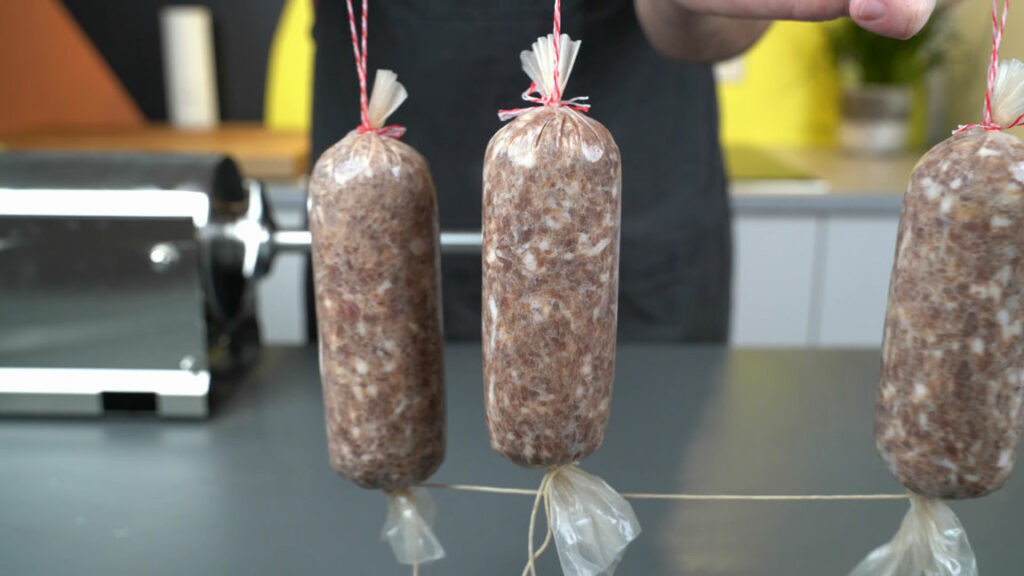 Beef salami before curing color development, with a grayish color