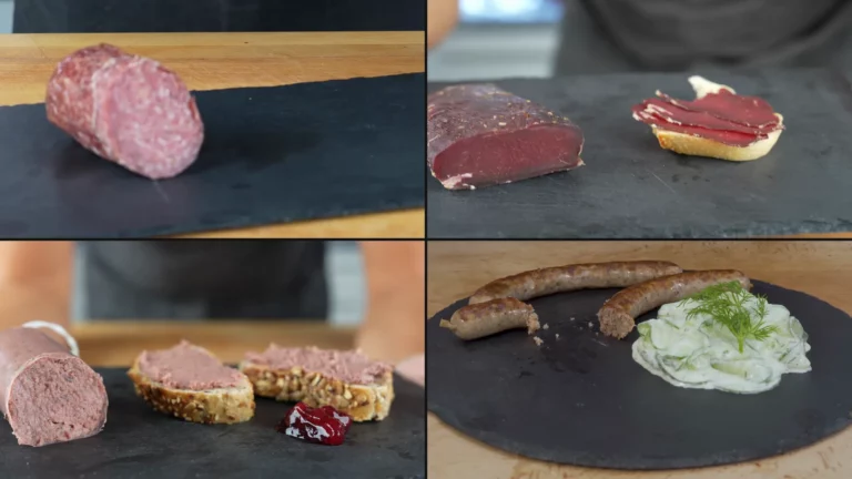 Wild boar salami, roe deer ham, game liverwurst and game bratwurst with cucumber salad on slate